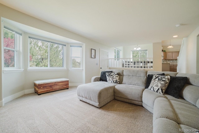15389 E 99th Way, Commerce City, CO 80022 - living area with baseboards, a chandelier, and light carpet