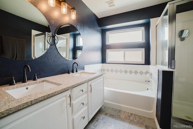 15389 E 99th Way, Commerce City, CO 80022 - full bathroom featuring a bath, double vanity, a stall shower, and a textured wall