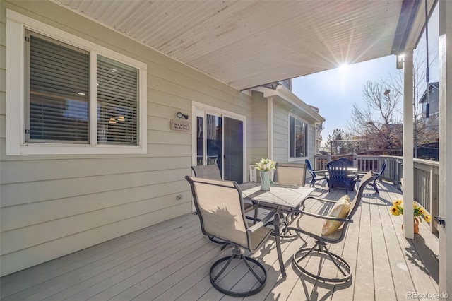wooden deck featuring outdoor dining area