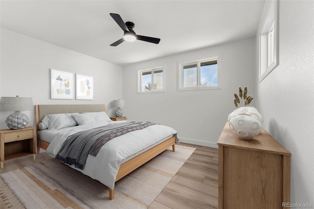 bedroom with ceiling fan and light hardwood / wood-style floors