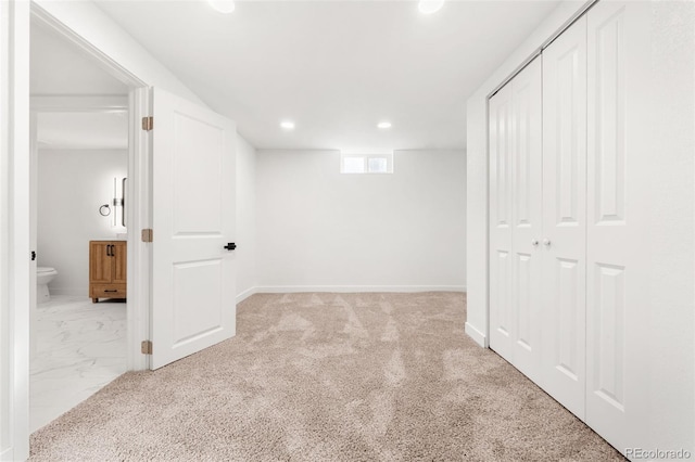 basement featuring light colored carpet