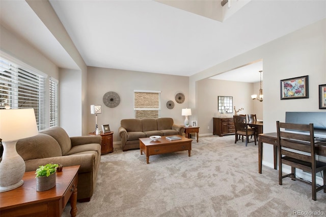 living room featuring an inviting chandelier and light colored carpet