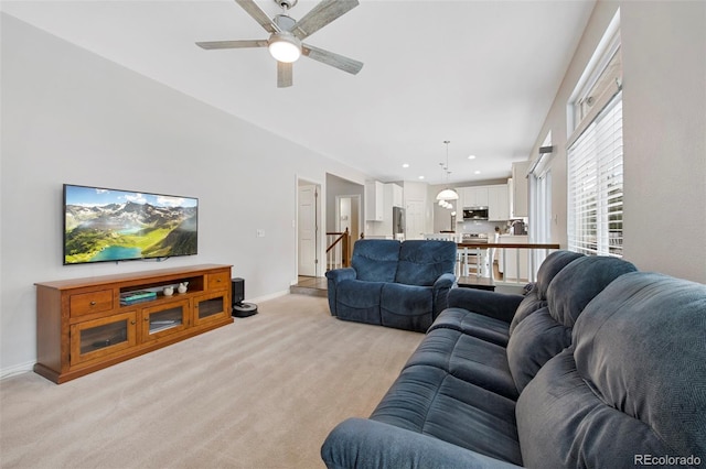 living room featuring light colored carpet and ceiling fan