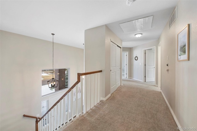 hallway featuring light colored carpet