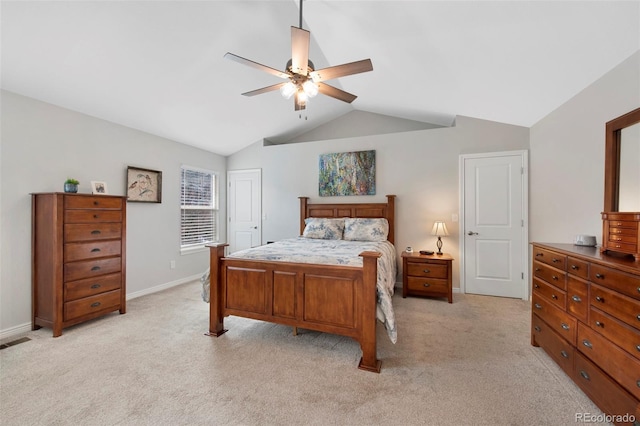 bedroom with ceiling fan, light colored carpet, and vaulted ceiling