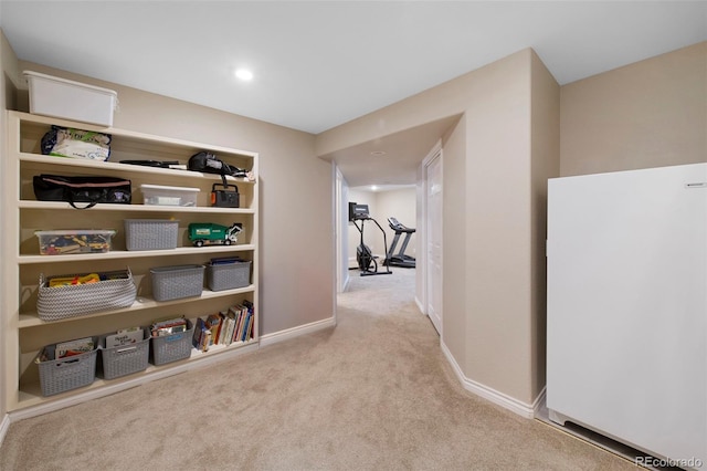 hallway featuring light colored carpet