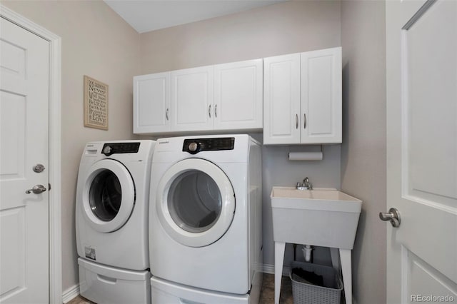 laundry room featuring cabinets and washing machine and dryer