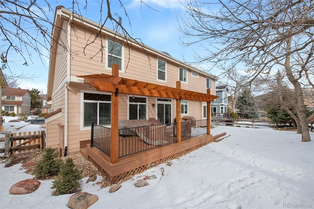 snow covered property with a pergola