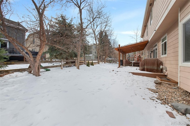 snowy yard featuring a pergola