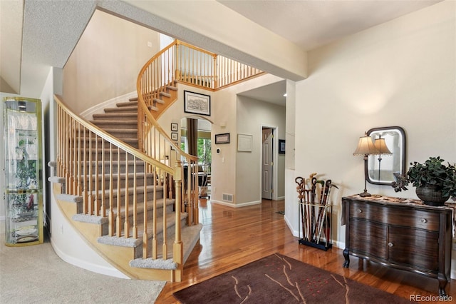 15962 W 70th Dr, Arvada, CO 80007 - staircase featuring wood finished floors and arched walkways