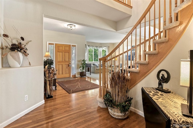 15962 W 70th Dr, Arvada, CO 80007 - foyer entrance with wood finished floors and stairway