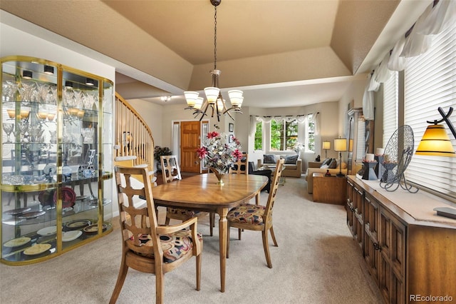 15962 W 70th Dr, Arvada, CO 80007 - dining area featuring light colored carpet, stairway, a chandelier, and a raised ceiling