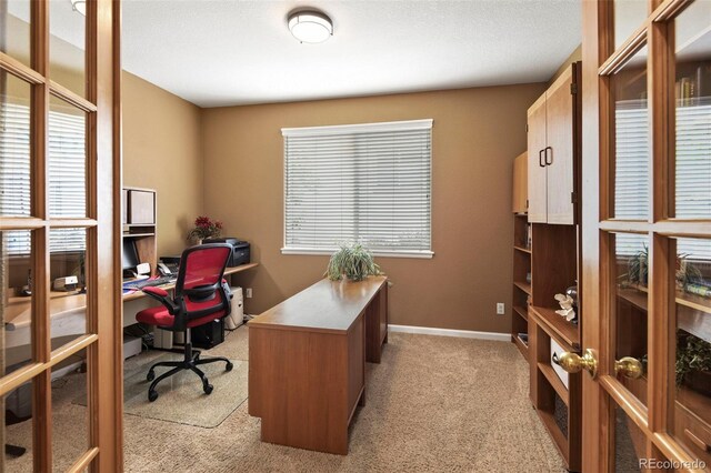 15962 W 70th Dr, Arvada, CO 80007 - office area with light colored carpet, plenty of natural light, and french doors