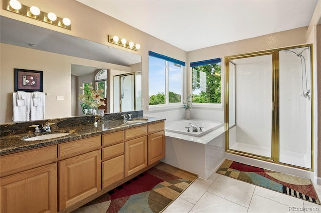 15962 W 70th Dr, Arvada, CO 80007 - full bath with double vanity, a stall shower, tile patterned flooring, and a garden tub