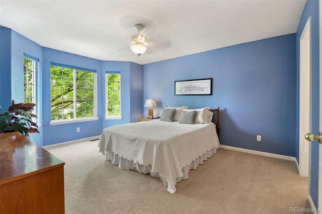 15962 W 70th Dr, Arvada, CO 80007 - bedroom featuring light colored carpet, multiple windows, and a ceiling fan
