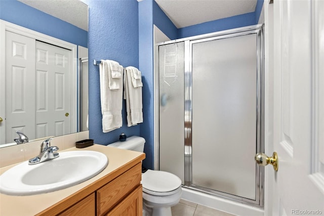 15962 W 70th Dr, Arvada, CO 80007 - full bath featuring a stall shower, vanity, tile patterned flooring, a textured wall, and a textured ceiling