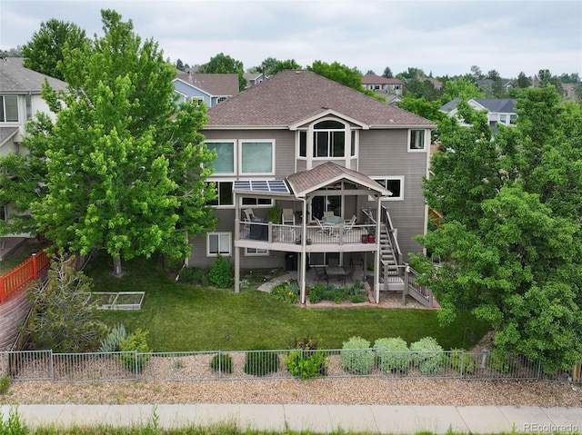 15962 W 70th Dr, Arvada, CO 80007 - rear view of property featuring a deck, a fenced backyard, roof with shingles, and stairs
