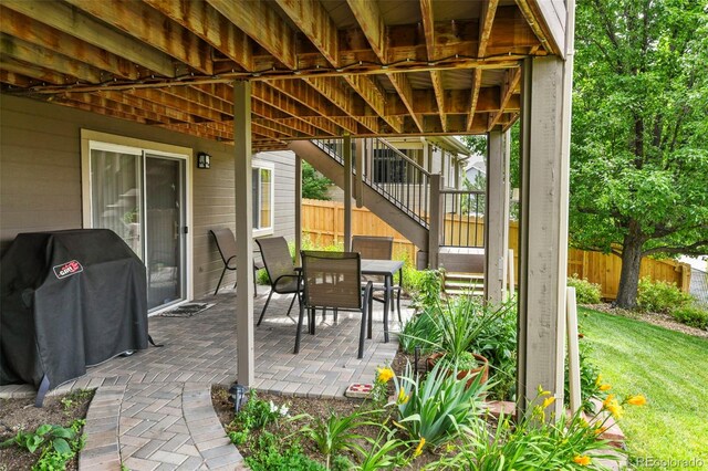 15962 W 70th Dr, Arvada, CO 80007 - view of patio featuring stairway, area for grilling, and outdoor dining area