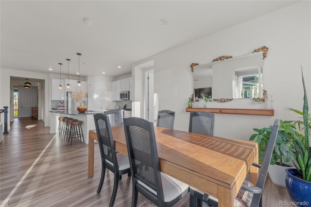 14431 Forest St, Thornton, CO 80602 - dining area featuring light wood finished floors and recessed lighting