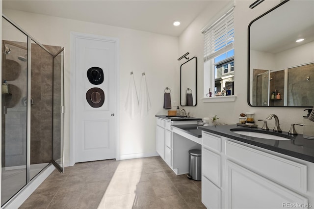 14431 Forest St, Thornton, CO 80602 - full bathroom featuring a stall shower, two vanities, and recessed lighting