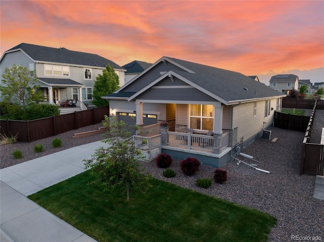 14431 Forest St, Thornton, CO 80602 - view of front facade featuring covered porch, concrete driveway, and central air condition unit