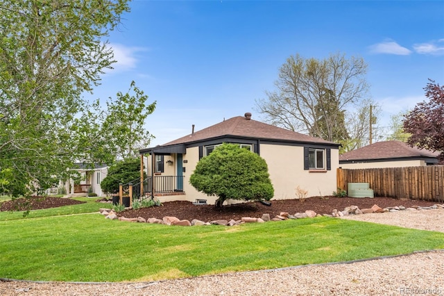 bungalow-style house with stucco siding and a shingled roof