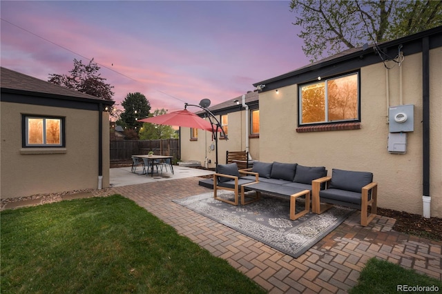 patio terrace at dusk featuring an outdoor living space