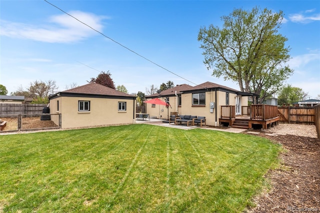 back of property with a deck, stucco siding, outdoor lounge area, and a patio