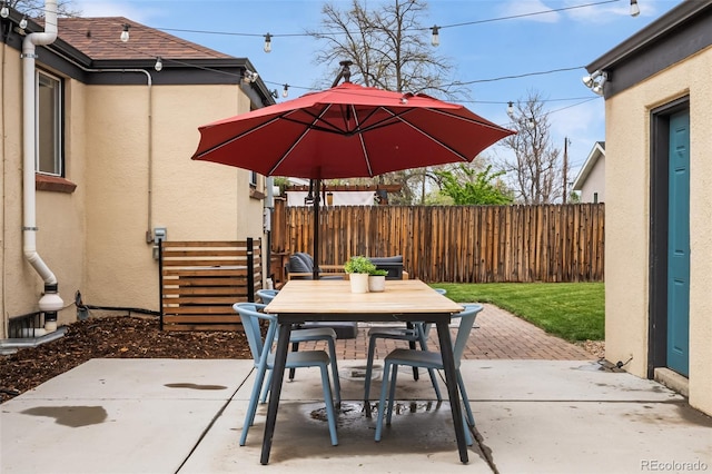 view of patio / terrace featuring outdoor dining area and fence