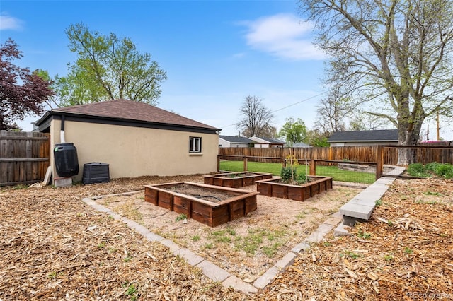 view of yard with central air condition unit and a vegetable garden