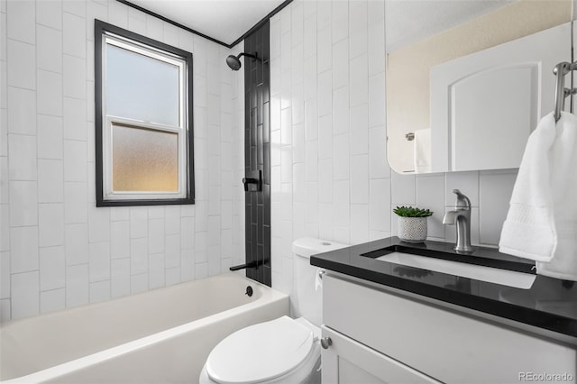 bathroom featuring shower / bath combination, toilet, vanity, and tile walls