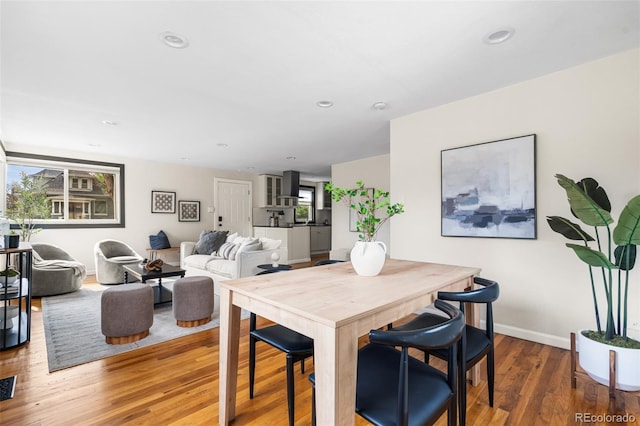 dining area featuring wood finished floors, baseboards, and recessed lighting