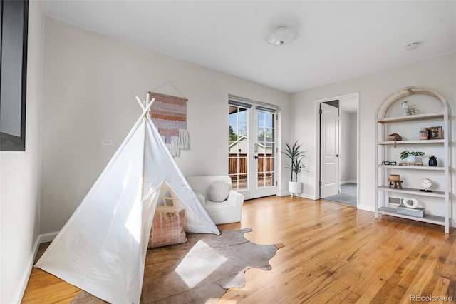 playroom featuring wood finished floors and baseboards