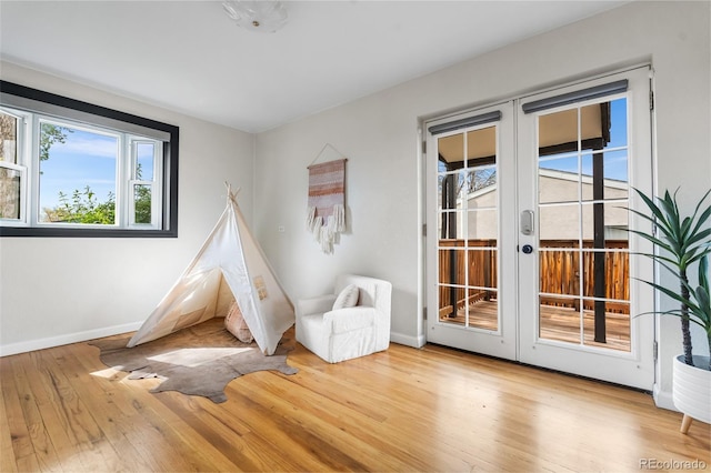 playroom with french doors, baseboards, and wood finished floors