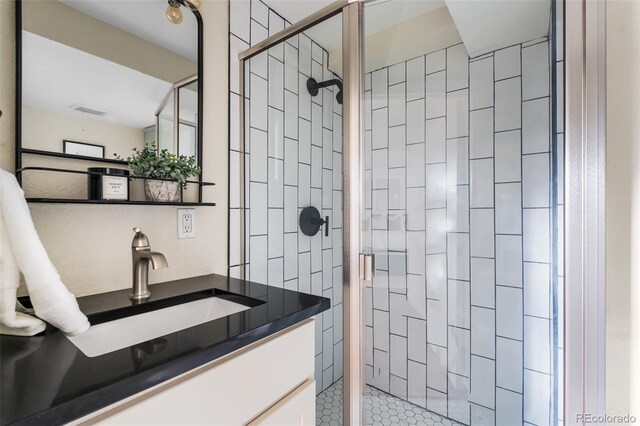 bathroom featuring a stall shower and vanity