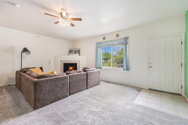 18038 Becket Dr, Parker, CO 80134 - carpeted living area with a ceiling fan, a glass covered fireplace, baseboards, and tile patterned flooring