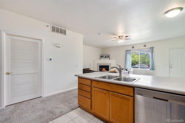 18038 Becket Dr, Parker, CO 80134 - kitchen featuring dishwasher, a sink, a warm lit fireplace, ceiling fan, and light colored carpet