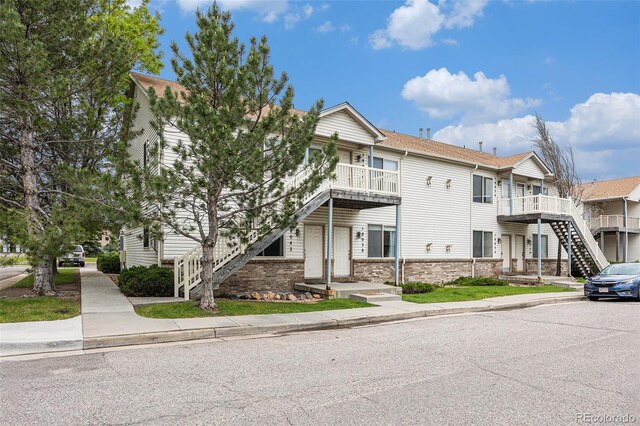 18038 Becket Dr, Parker, CO 80134 - view of property featuring stairs and a balcony