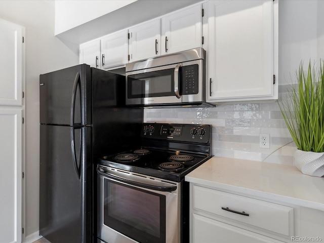 kitchen featuring appliances with stainless steel finishes, white cabinets, and backsplash