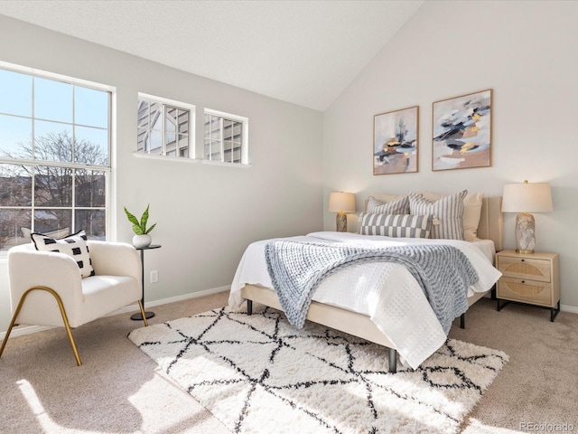 bedroom with light carpet, baseboards, and lofted ceiling