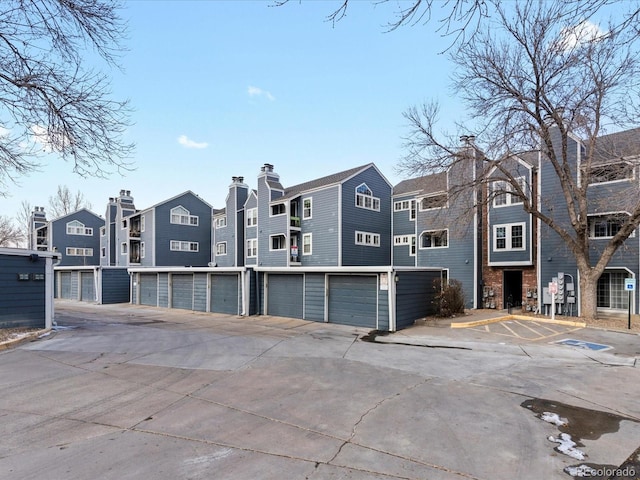 exterior space featuring a residential view and community garages