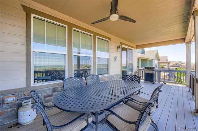 7845 S Flat Rock Way, Aurora, CO 80016 - wooden terrace with outdoor dining space, ceiling fan, and a grill