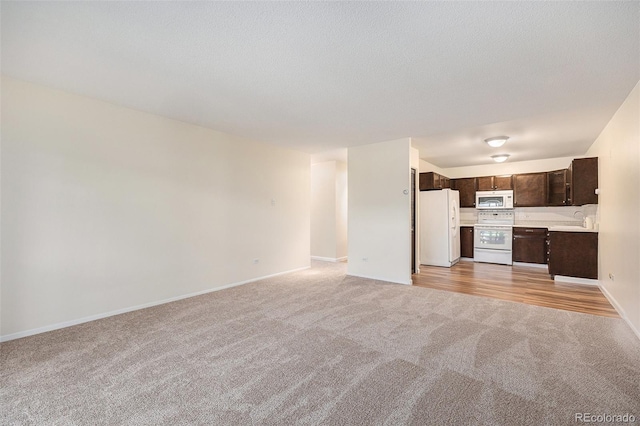 350 S Clinton St Unit 2A, Denver, CO 80247 - unfurnished living room with light carpet and baseboards