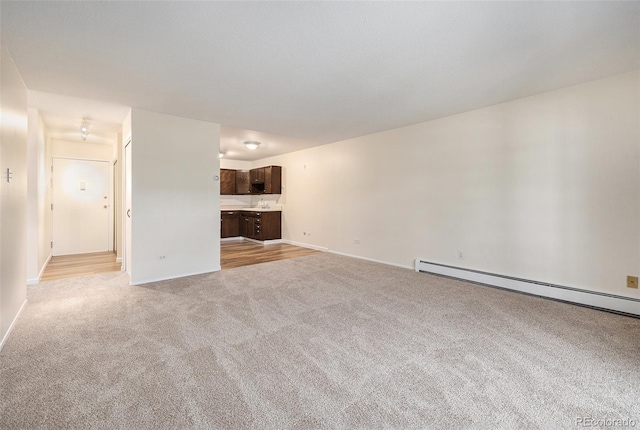 350 S Clinton St Unit 2A, Denver, CO 80247 - unfurnished living room with light colored carpet and baseboard heating