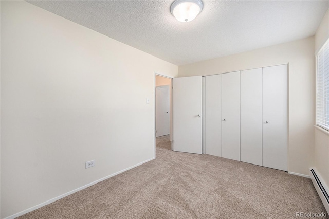 350 S Clinton St Unit 2A, Denver, CO 80247 - unfurnished bedroom with a baseboard radiator, light colored carpet, a textured ceiling, and a closet