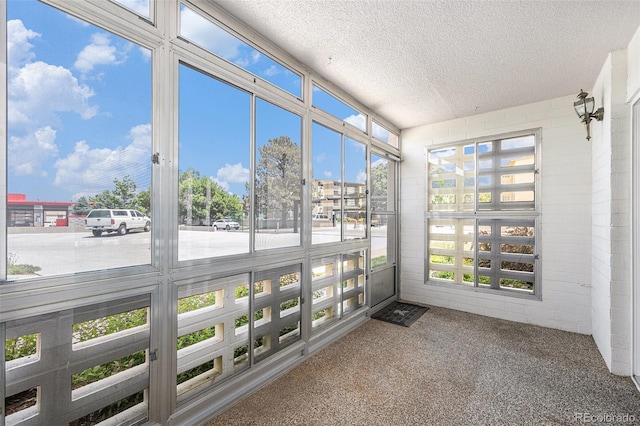 350 S Clinton St Unit 2A, Denver, CO 80247 - unfurnished sunroom with a textured ceiling and carpet flooring