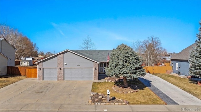 view of front of property featuring an attached garage, fence, concrete driveway, and brick siding