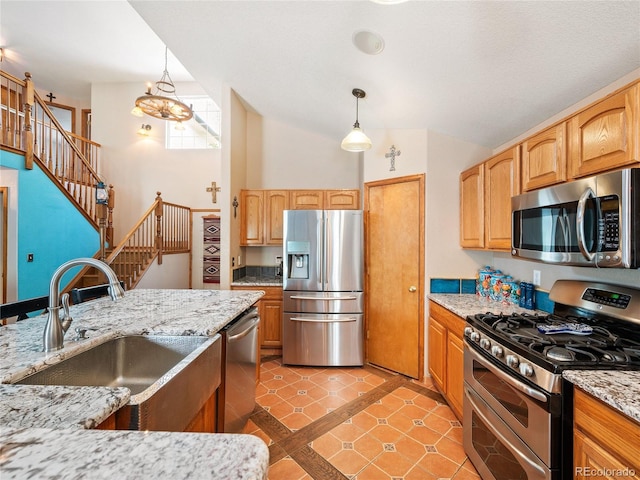 kitchen with appliances with stainless steel finishes, high vaulted ceiling, decorative light fixtures, sink, and light stone countertops