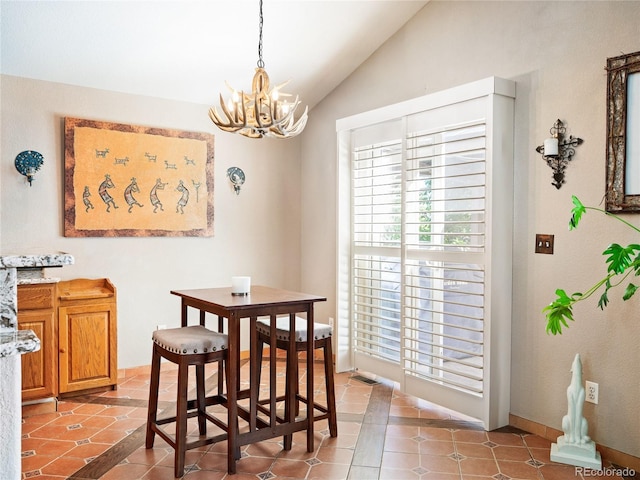 dining area with lofted ceiling, tile patterned flooring, and a chandelier