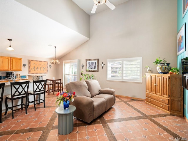 living room featuring ceiling fan with notable chandelier, tile patterned floors, and high vaulted ceiling